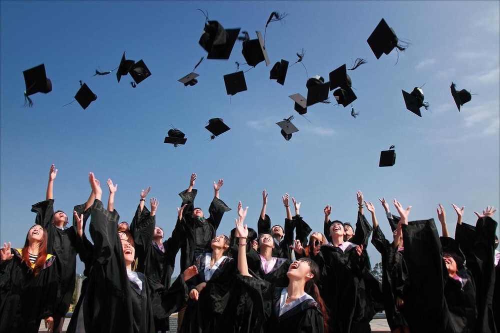 Graduates throwing their caps